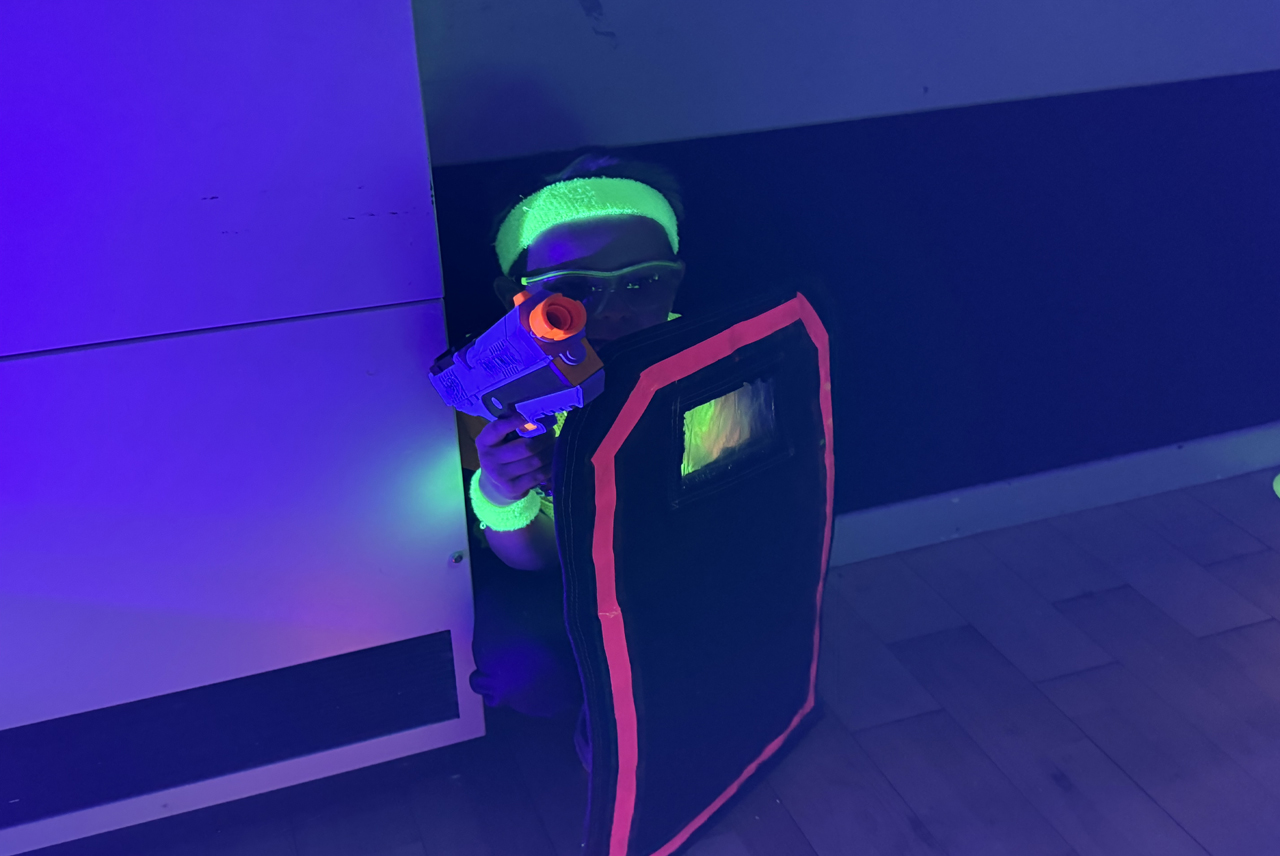Children enjoying UV Nerf party games with glowing equipment